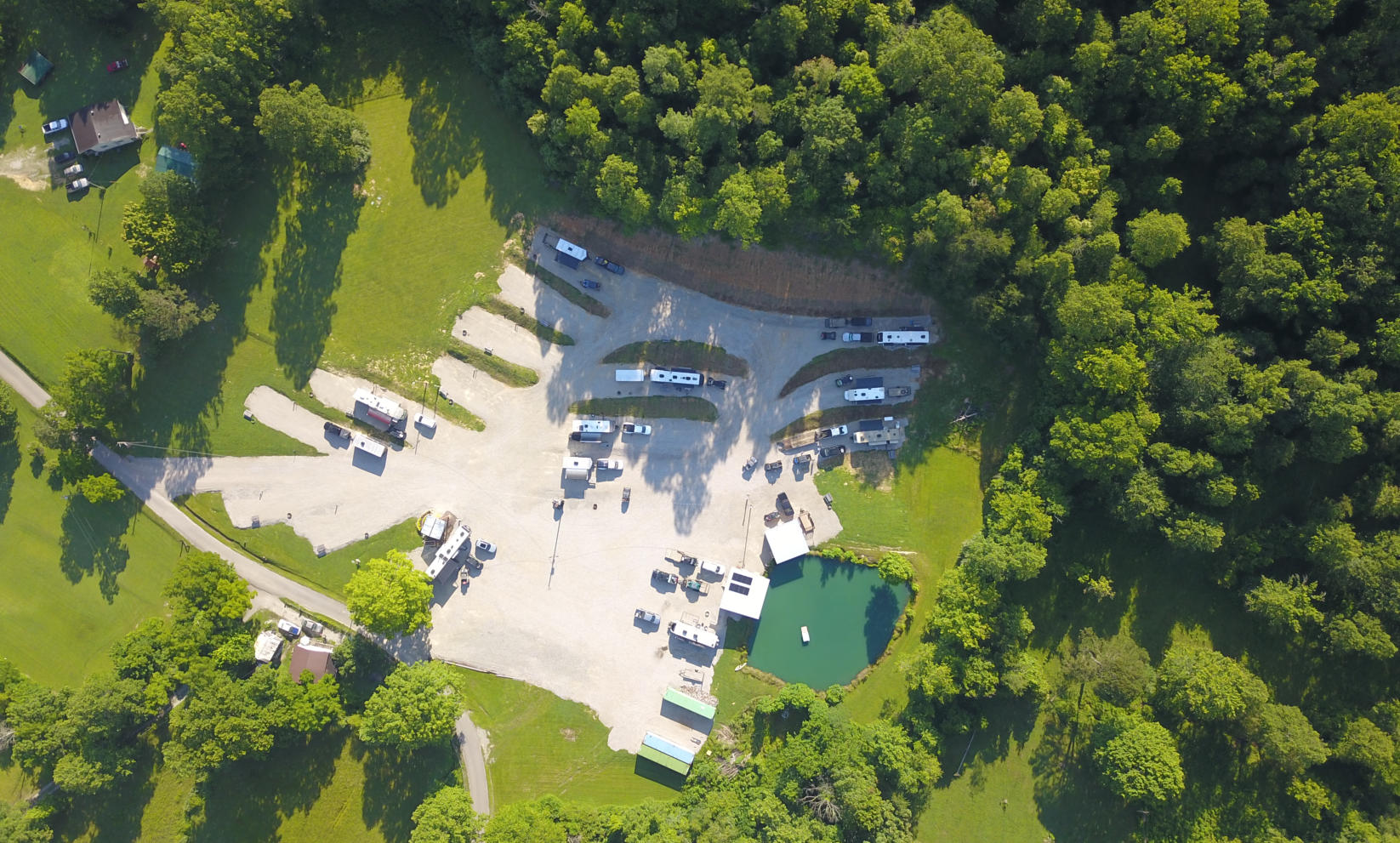 an aerial picture of our campground showing the rv sites, cabins, atv wash station